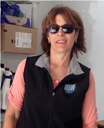 A woman wearing sunglasses and a vest.