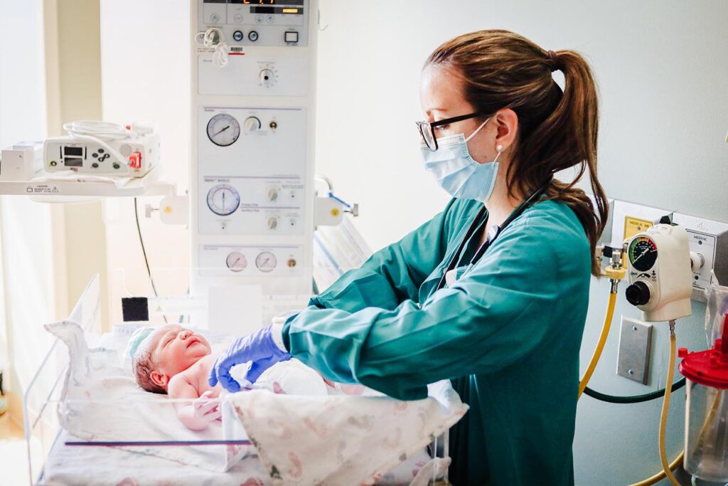 photo of female doctor caring for a baby